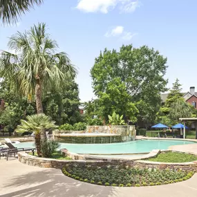Resort style pool with tanning shelf wifi water features and grills at Camden Holly Springs Apartments in Houston, TX