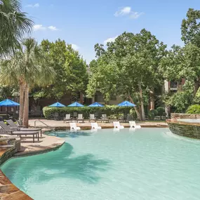 Resort style pool with tanning shelf wifi water features and grills at Camden Holly Springs Apartments in Houston, TX
