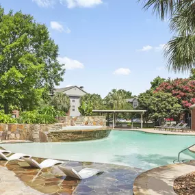 Resort-style pool with sun shelf at Camden Holly Springs apartments in Houston, TX