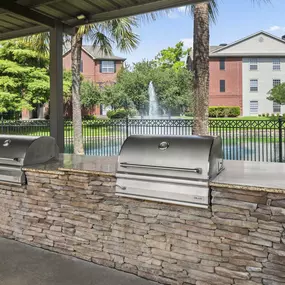 Poolside BBQ grills at Camden Holly Springs apartments in Houston, TX