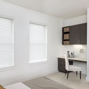 White quartz finishes in bedroom with built-in desk