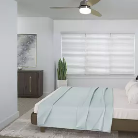 Black granite finishes in bedroom with ceiling fan and large window