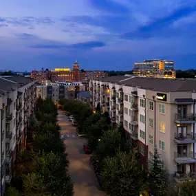 Building exterior with private balconies looking at ponce city market at dusk