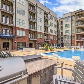 Outdoor grill next to resort style pool