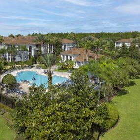 Community pool with lush landscaping at Camden World Gateway apartment community in Orlando, FL