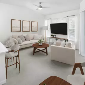 Open-concept living room with plush carpet and private balcony at Camden World Gateway apartments in Orlando, FL