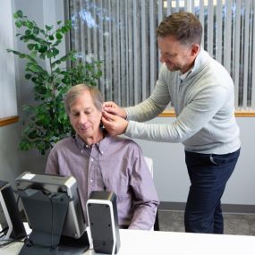 Matt Wilken (Founder & Audiologist) fits hearing aids