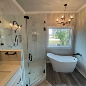 Remodeled a dark and outdated bathroom. The design created a beautiful new space with free-standing tub, lighting, tile shower, cabinets, countertops and flooring.