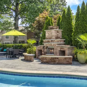 Outdoor fireplace next to saltwater pool at Camden Fairview in Charlotte North Carolina