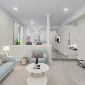 Modern living room and adjacent dining area with hardwood-style flooring at Camden Fairview in Charlotte, NC