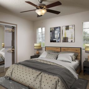 Large bedroom with mirrored closet doors in traditional finish style at Camden Doral apartments