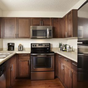 Kitchen in traditional finish style with energy efficient stainless steel appliances including microwave