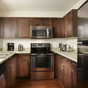 Kitchen in traditional finish style with energy efficient stainless steel appliances including microwave