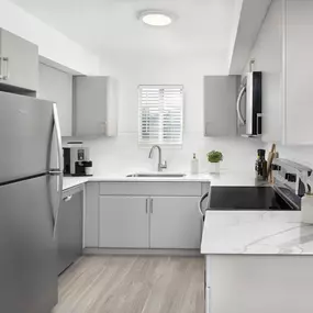 Apartment home kitchen with modern finishes and stainless steel appliances at Camden Doral in Doral Florida