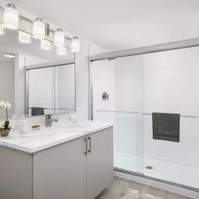 Apartment home bathroom with modern finishes and walk-in shower