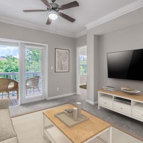 Camden Peachtree City apartments in Peachtree City, GA living room with ceiling fan and view of balcony