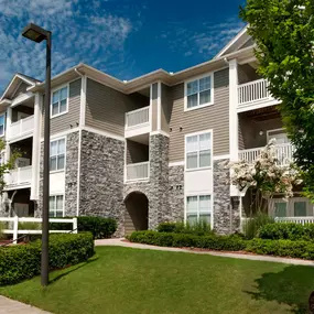 Building exterior showing private balconies and patios as well as beautiful landscaping