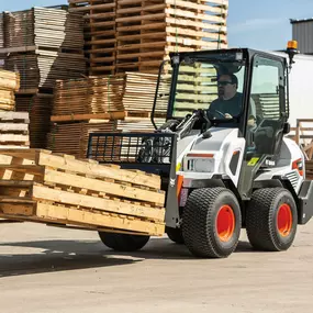 A Bobcat L23 small articulated loader with bucket attachment