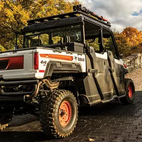 A Bobcat L28 small articulated loader with pallet fork attachment