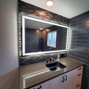 This lighted mirror makes the beautiful tile in the bathroom glow!