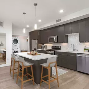 Open concept floor plan with stacked full size washer and dryer