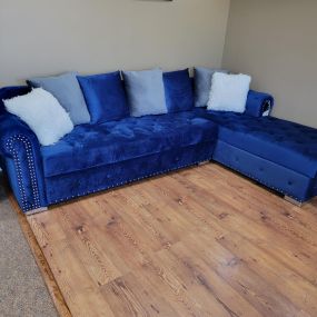 Plush blue sectional ready to make your living room that cozy corner.