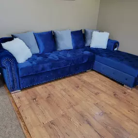 Plush blue sectional ready to make your living room that cozy corner.