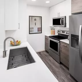 Gourmet kitchen with quartz countertops and single-basin undermount sink at Camden Potomac Yard apartments in Arlington, VA