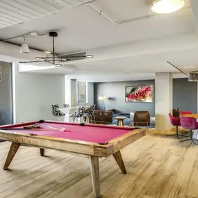 Resident lounge with billiards table and lounge seating at Camden Potomac Yard apartments in Arlington, VA.