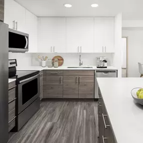 Spacious kitchen with stainless steel appliances, white quartz countertops, and white subway tile backsplash at Camden Potomac Yard Apartments in Arlington, VA