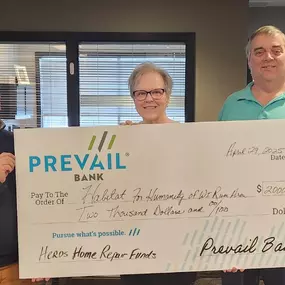 Prevail Bank charitable contribution 'big check' to Habitat for Humanity.