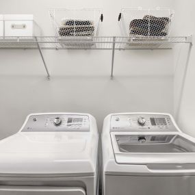 Full size washer dryer side by side with shelving above