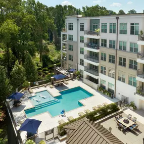 Outdoor lounge area with fire pits and resort-style pool