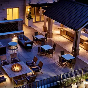 Outdoor lounge with fire pits and grills nighttime view