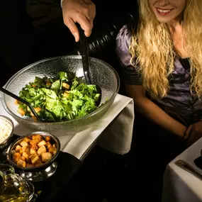 A Tableside Affair! Experience the artistry of our chef as they prepare the famous Caesar salad right before your eyes.