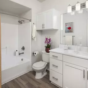 Bathroom with white quartz countertops and nickel fixtures