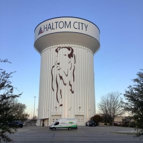 One of the Tioga service vans in front of a Haltom City water tower in Haltom City Texas.