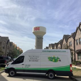 A Tioga service van in a Frisco Texas neighborhood in front of a Frisco water tower.