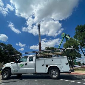 A Tioga service truck in front of Six Flags rides in Arlington Texas.