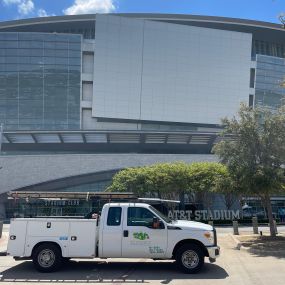 A Tioga Plumbing And Electric service truck in front of the AT&T stadium in Arlington Texas.