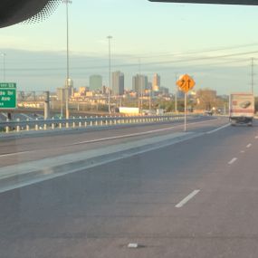 A Tioga Plumbing & Electric vehicle driving into down town Fort Worth Texas.