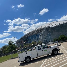 A Tioga Plumbing & Electric tech with his truck at the AT&T Stadium in Arlington Texas.