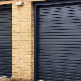 A set of garage doors spray painted in anthracite grey, creating a fresh, clean and new appearance