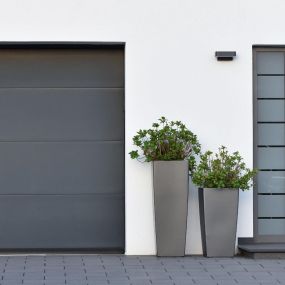 front door and a garage door spray painted in two shades of grey