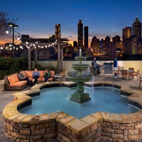 Outdoor rooftop resident lounge with seating dining and barbeque areas