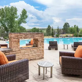 Fireplace with lounge seating by the resort-style pool