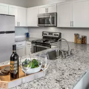 Kitchen with quartz countertops and white cabinets