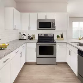 Kitchen with wood-style flooring and stainless steel appliances