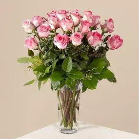 Picture–perfect soft pink roses make a beautiful gift for the lovely lady in your life. Wife, mother, daughter or sweetheart, she's sure to cherish this bouquet of pastel pink roses accented with seeded eucalyptus and arranged in a clear glass vase.