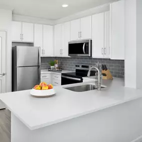 Kitchen with quartz countertops at Camden Montague apartments in Tampa, FL